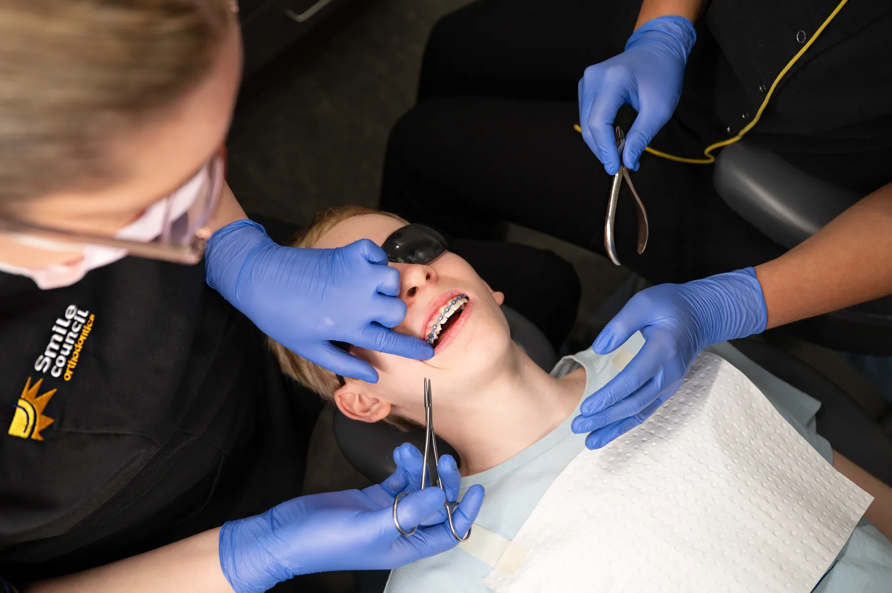 Smile Council staff adjusting a patient's braces