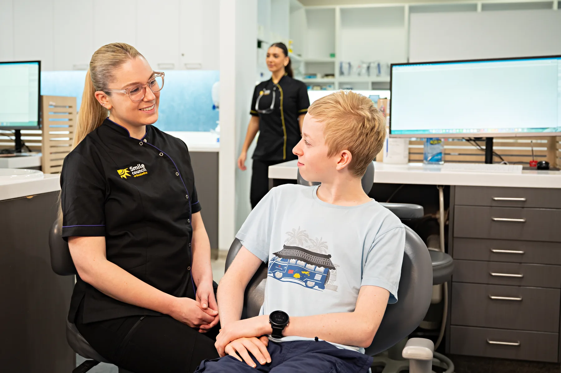 Smile Council staff talking with a young patient