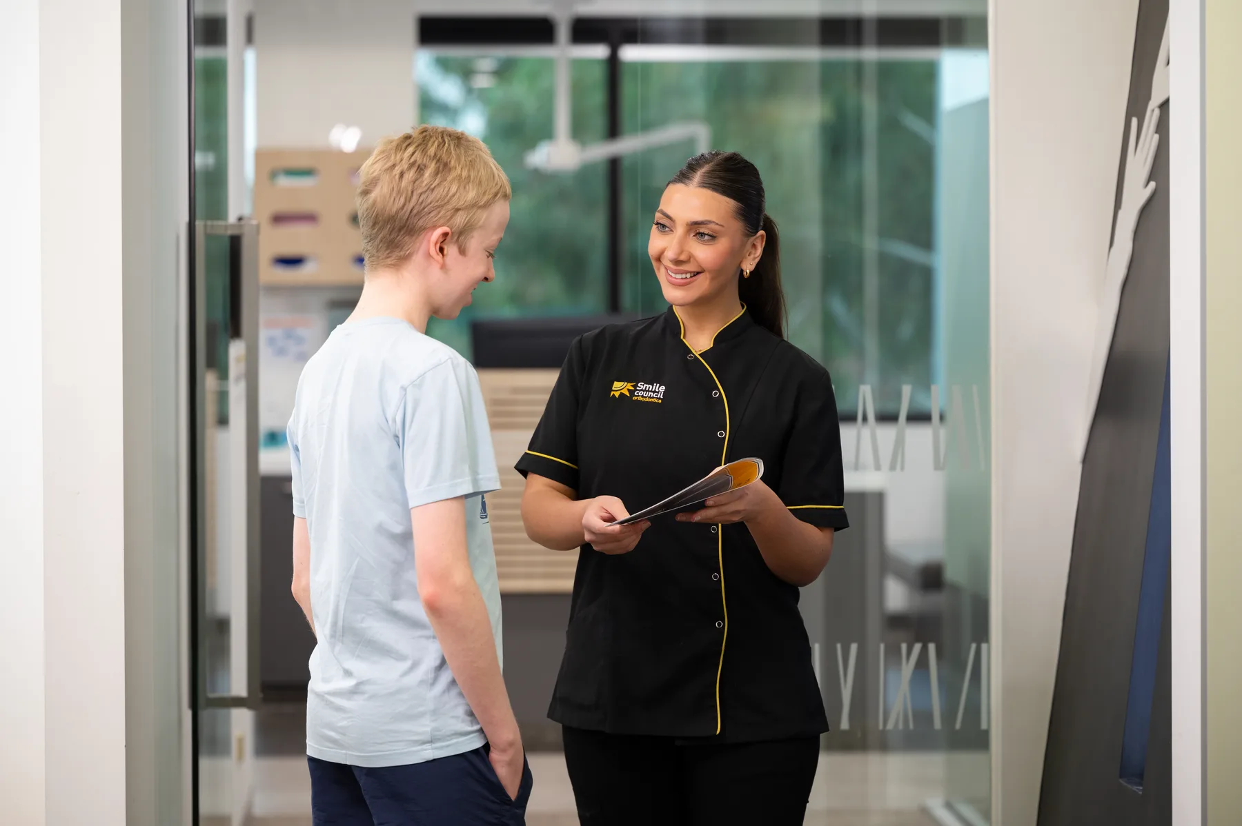 Smile Council staff talking with a young patient